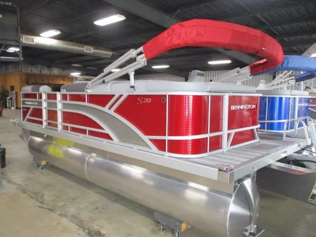 The Image of 2025 Bennington 20SL pontoon boat with red accents in a showroom. - 1