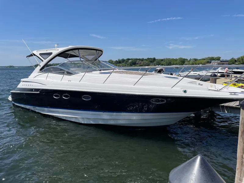 The Image of 2008 Regal Commodore 4460 yacht docked on a sunny day, featuring sleek design and spacious deck. - 0