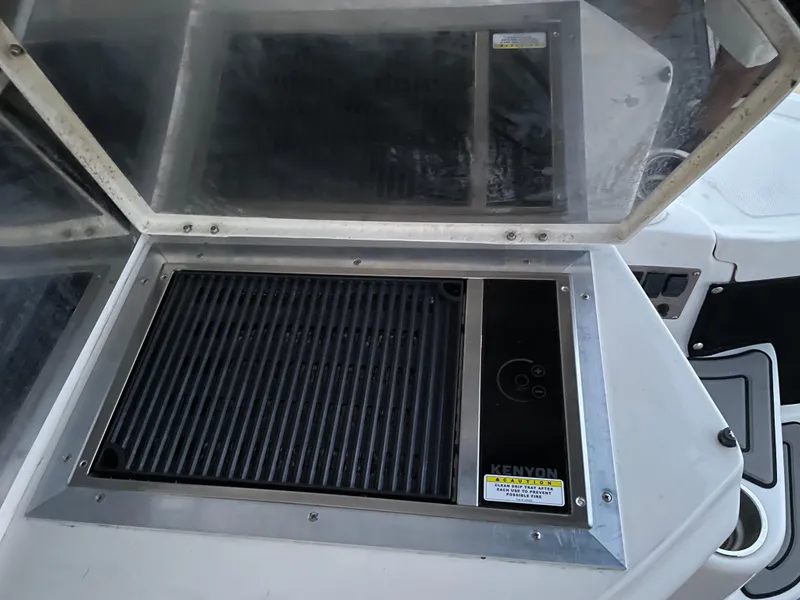Slide: The Image of Built-in grill on 2008 Regal Commodore 4460 yacht, featuring Kenyon electric cooktop. - 10