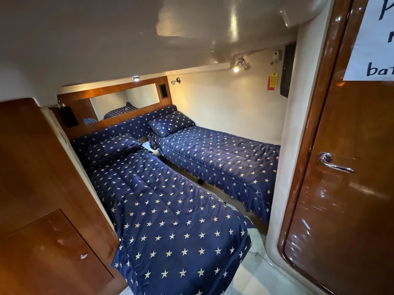 Slide: The Image of Twin cabin with star-patterned bedding in 2008 Regal Commodore 4460 yacht. - 12