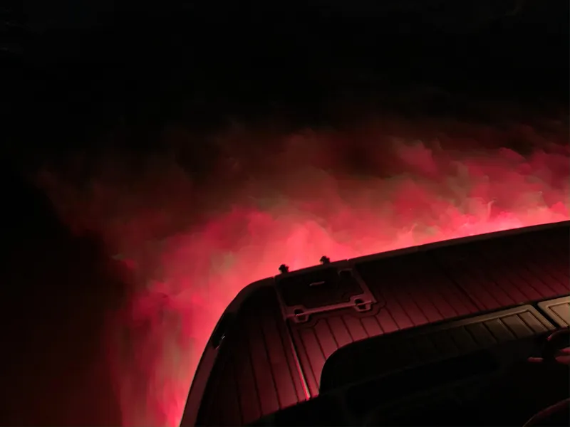 Slide: The Image of 2008 Regal Commodore 4460 boat with red underwater lights at night. - 18