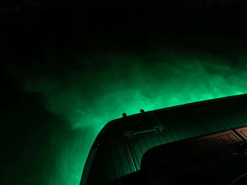 Slide: The Image of 2008 Regal Commodore 4460 boat with glowing green underwater lights at night. - 19