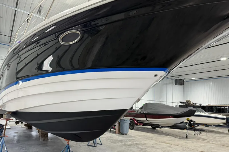 Slide: The Image of 2008 Regal Commodore 4460 yacht in storage, showcasing sleek black and white hull design. - 20