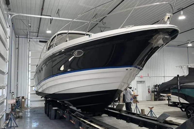 Slide: The Image of 2008 Regal Commodore 4460 yacht in a spacious indoor storage facility. - 21