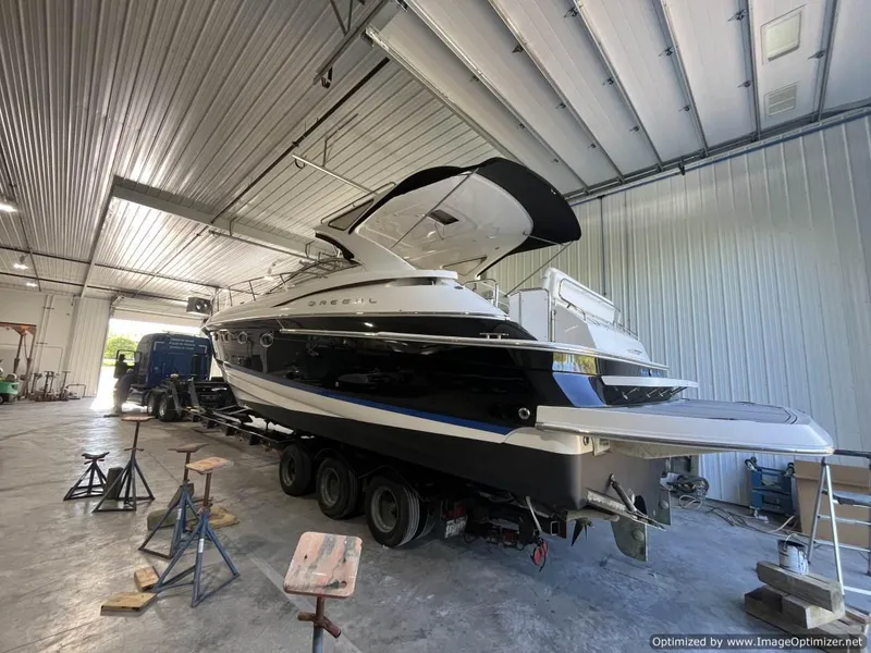 Slide: The Image of 2008 Regal Commodore 4460 yacht in a spacious indoor storage facility. - 25