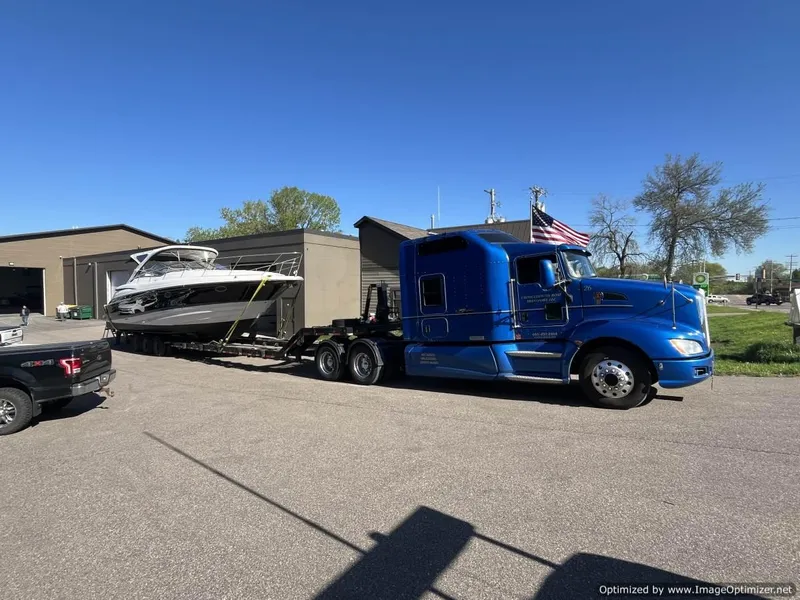 Slide: The Image of Blue truck transporting 2008 Regal Commodore 4460 boat on trailer, sunny day. - 26