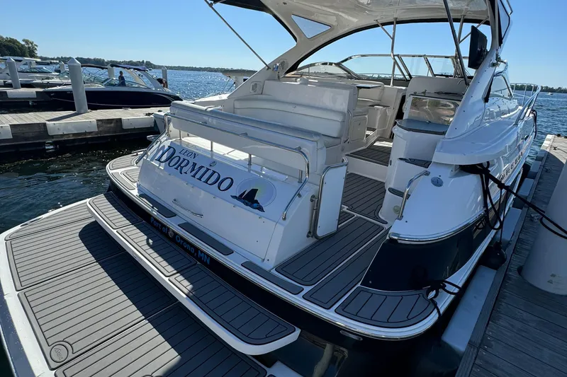 Slide: The Image of 2008 Regal Commodore 4460 yacht docked at marina, featuring spacious deck and seating area. - 5