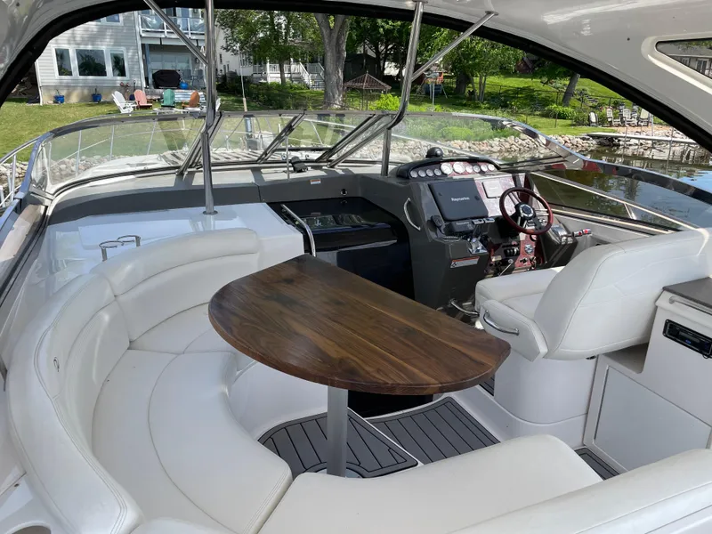 Slide: The Image of Luxurious 2008 Regal Commodore 4460 yacht interior with elegant seating and wooden table. - 6