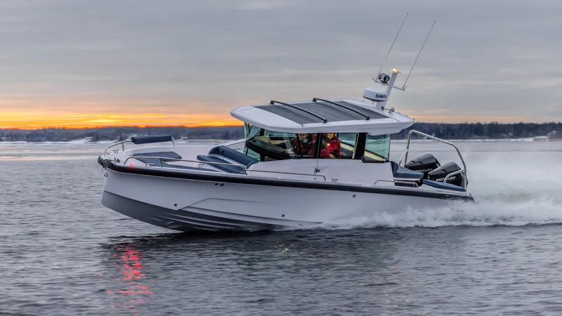 Slide: The Image of 2025 Axopar 29 Cross Cabin boat cruising on water at sunset. - 5