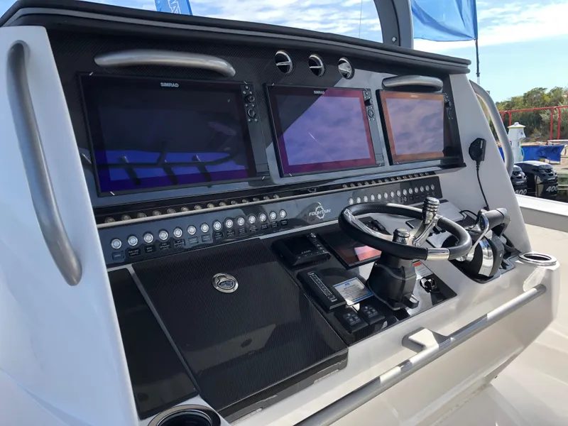 Slide: The Image of Control panel of 2020 Fountain 43 NX boat with multiple screens and steering wheel. - 4