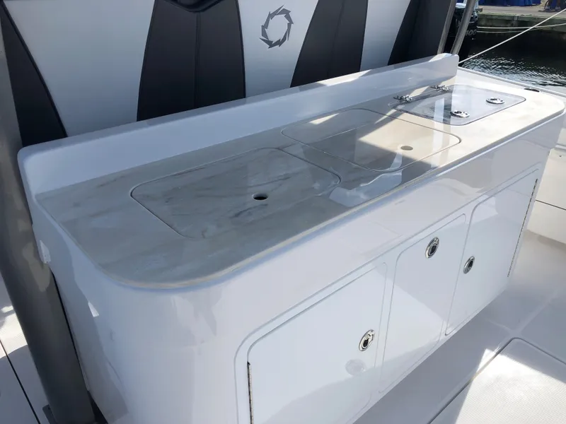 Slide: The Image of 2020 Fountain 43 NX boat interior with sleek countertop and storage compartments. - 5