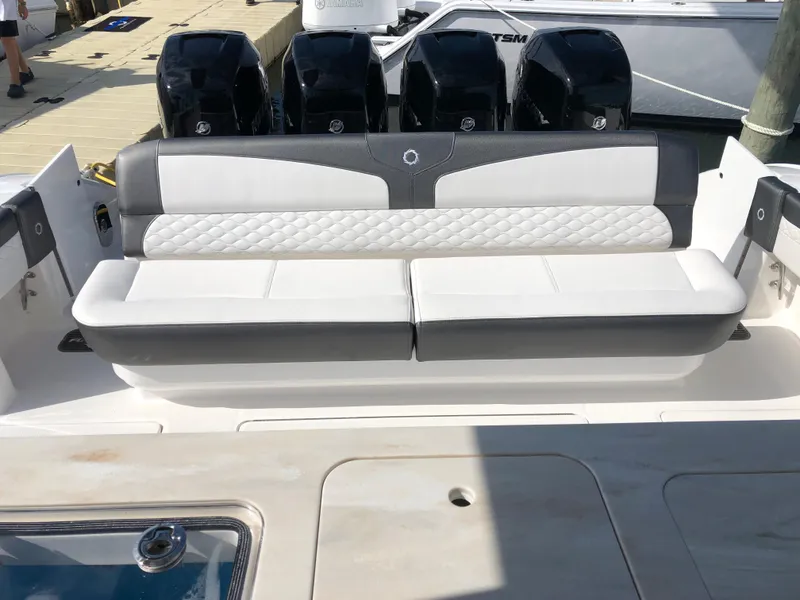 Slide: The Image of 2020 Fountain 43 NX boat with cushioned seating and multiple outboard engines. - 6