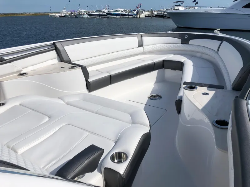 Slide: The Image of 2020 Fountain 43 NX boat interior with luxurious white seating and cup holders. - 8