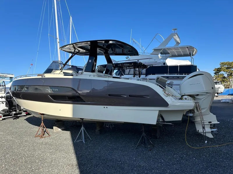 Slide: The Image of 2024 Invictus GT320S boat on display, sleek design, outdoor setting. - 1