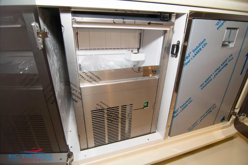 Slide: The Image of 2024 Invictus GT320S interior with built-in stainless steel refrigerator. - 10