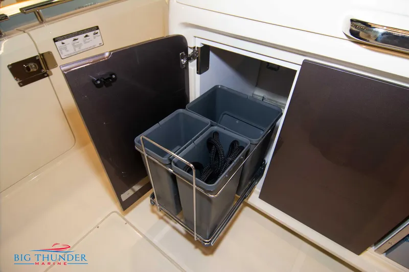 Slide: The Image of Open storage compartment with bins in 2024 Invictus GT320S boat. - 11