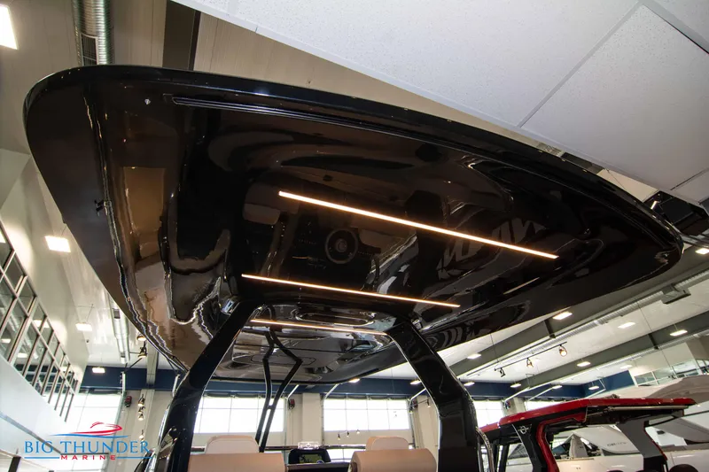Slide: The Image of 2024 Invictus GT320S boat interior with sleek black roof and modern lighting. - 12