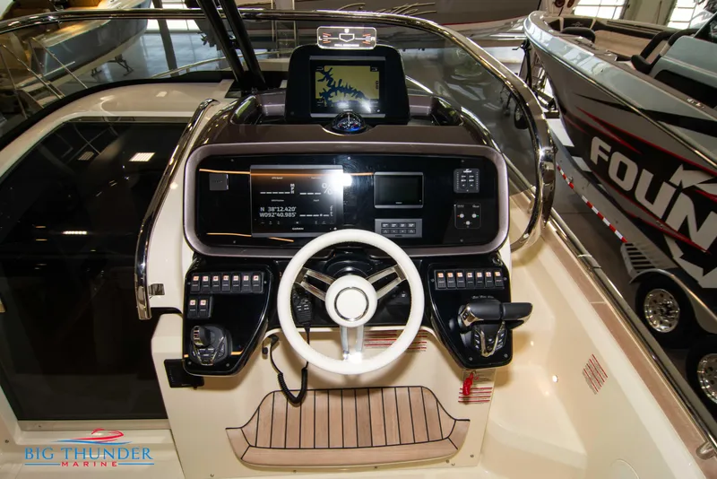 Slide: The Image of 2024 Invictus GT320S boat dashboard with advanced navigation and control systems. - 13