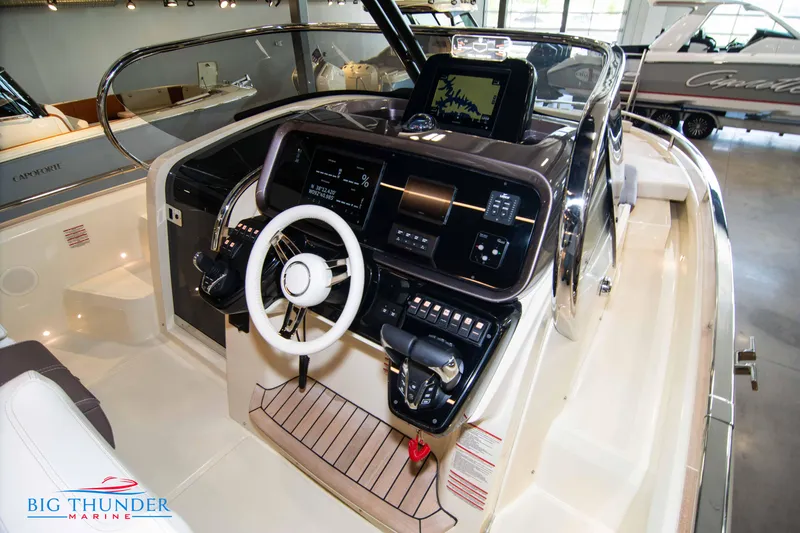 Slide: The Image of 2024 Invictus GT320S boat cockpit with modern controls and steering wheel at Big Thunder Marine. - 15