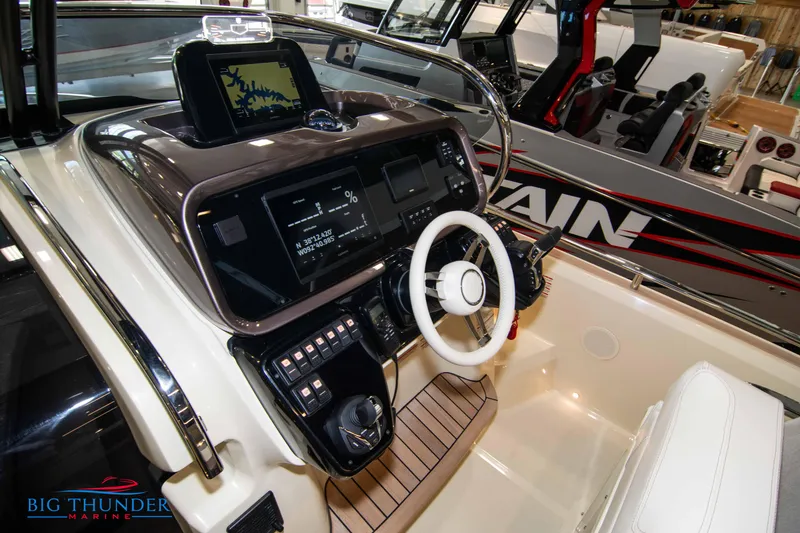 Slide: The Image of 2024 Invictus GT320S boat dashboard with modern controls and steering wheel. - 16