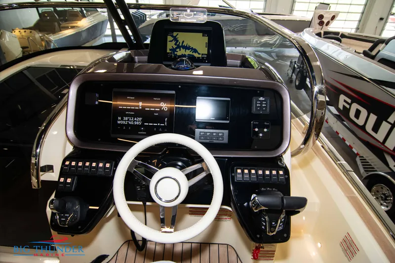 Slide: The Image of 2024 Invictus GT320S boat dashboard with modern controls and navigation display. - 17