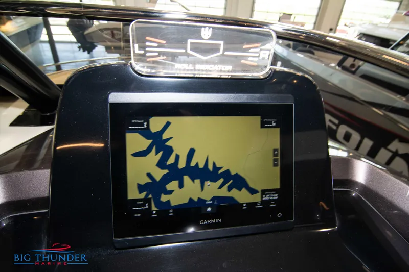 Slide: The Image of 2024 Invictus GT320S dashboard with Garmin navigation display at Big Thunder Marine showroom. - 18