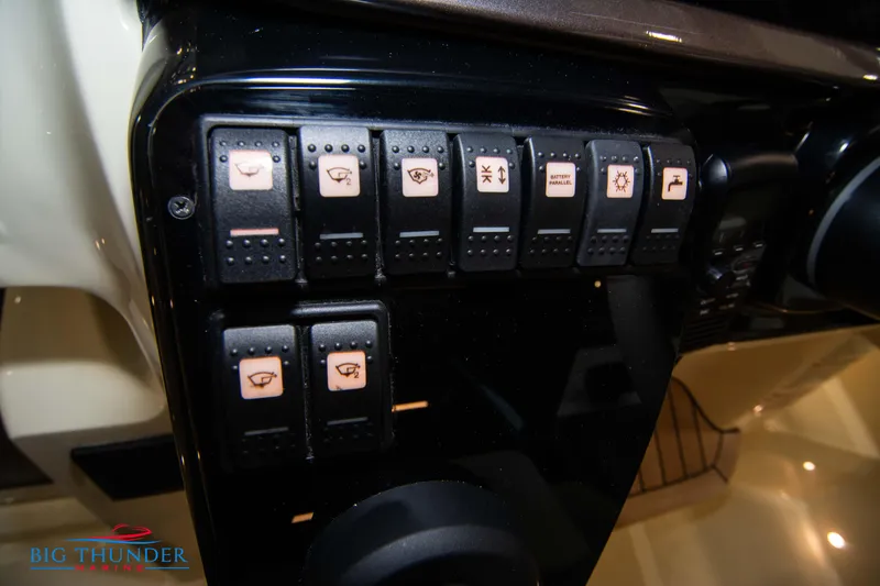 Slide: The Image of Dashboard controls of 2024 Invictus GT320S boat with labeled switches. - 21