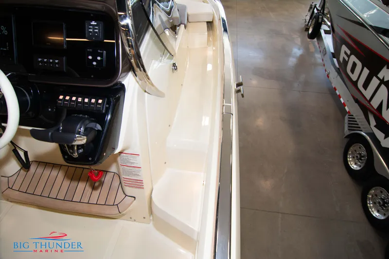 Slide: The Image of 2024 Invictus GT320S boat interior with control panel and seating area. - 35