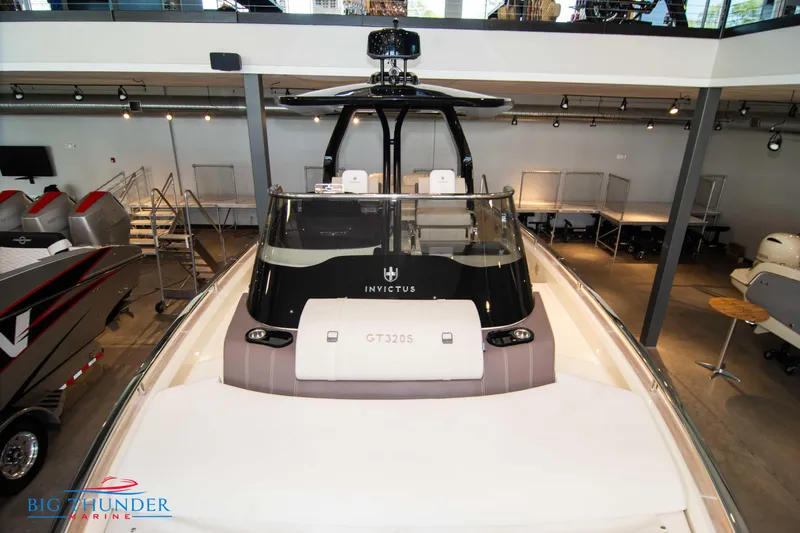 Slide: The Image of 2024 Invictus GT320S luxury boat displayed in a showroom. - 39