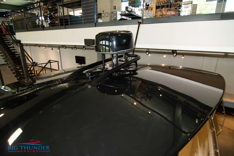 Slide: The Image of 2024 Invictus GT320S boat roof in showroom, featuring sleek black design. - 41