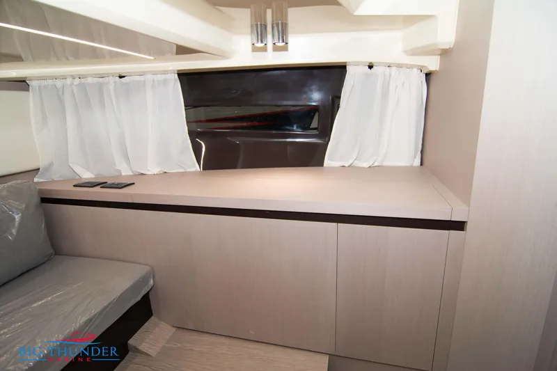 Slide: The Image of 2024 Invictus GT320S interior with modern design, featuring light wood cabinetry and white curtains. - 44