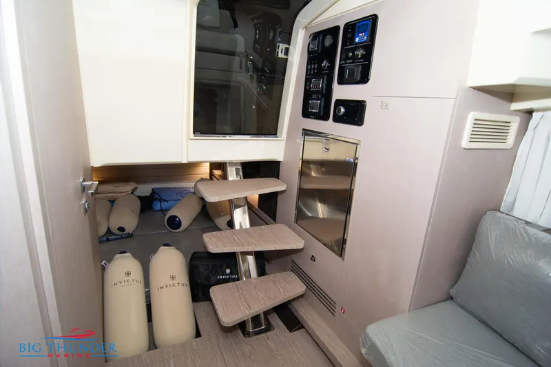 Slide: The Image of Interior of 2024 Invictus GT320S yacht with modern stairs and control panel. - 46