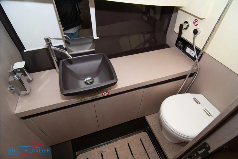Slide: The Image of 2024 Invictus GT320S bathroom interior with modern sink and toilet design. - 48