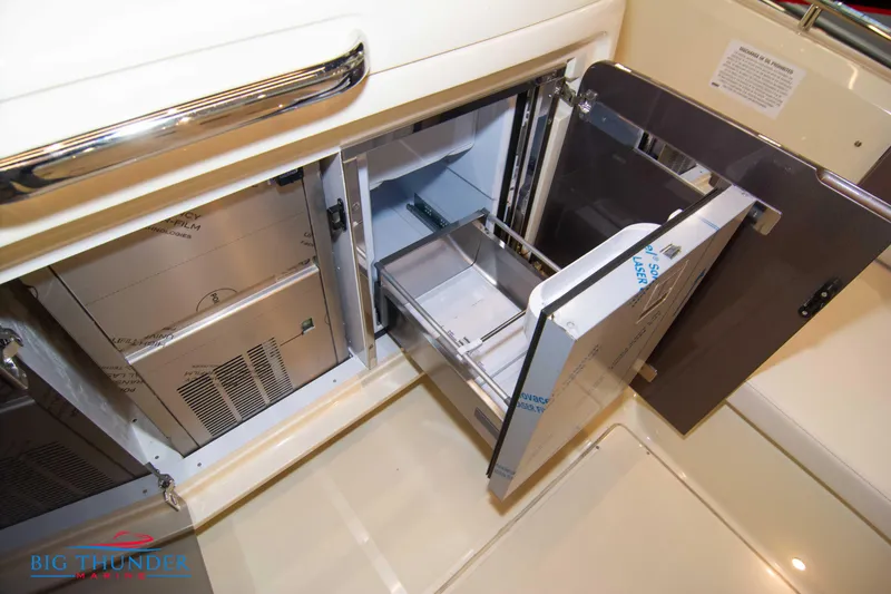 Slide: The Image of 2024 Invictus GT320S interior storage compartments with open drawers and sleek design. - 9