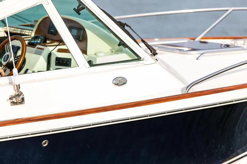 Slide: The Image of 2021 Hunt Yachts Harrier 26 boat, featuring sleek design and modern dashboard controls. - 13