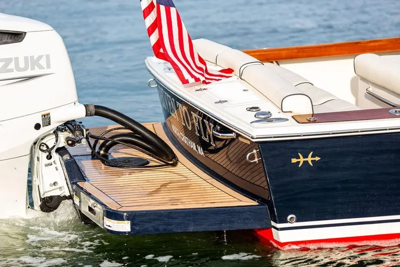 Slide: The Image of 2021 Hunt Yachts Harrier 26 with Suzuki engine, American flag, and teak swim platform. - 14