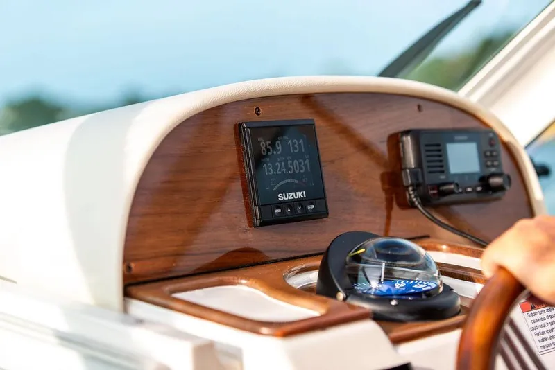 Slide: The Image of Helm of 2021 Hunt Yachts Harrier 26 with navigation instruments and compass. - 18