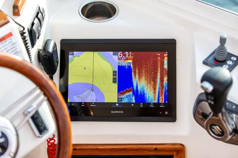Slide: The Image of Garmin navigation display on 2021 Hunt Yachts Harrier 26 dashboard, featuring sonar and map. - 21