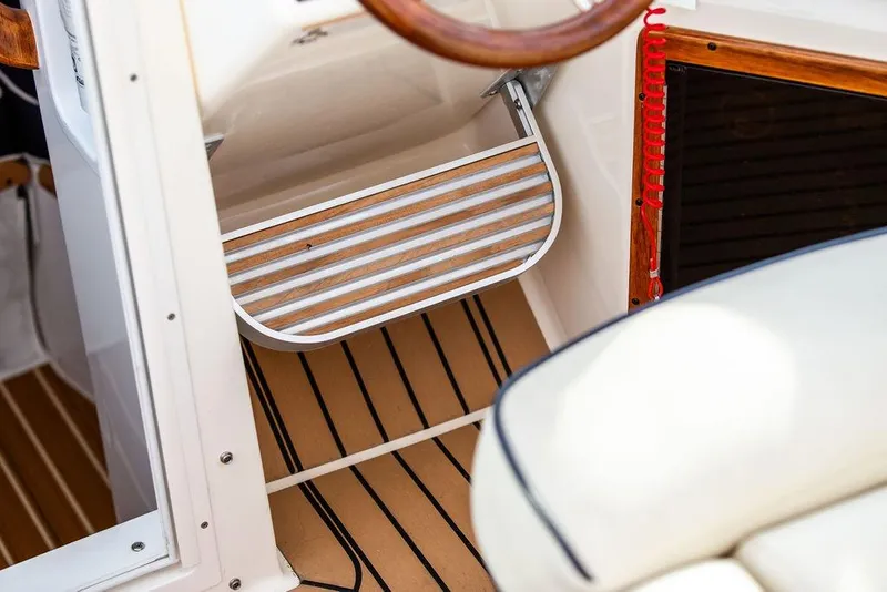 Slide: The Image of 2021 Hunt Yachts Harrier 26 interior with wooden step and nautical design elements. - 25