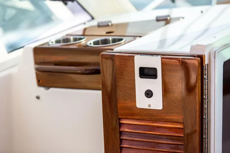 Slide: The Image of 2021 Hunt Yachts Harrier 26 interior with elegant wood finish and cup holders. - 26