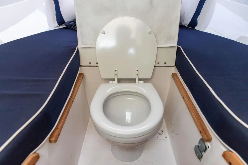 Slide: The Image of 2021 Hunt Yachts Harrier 26 interior with marine toilet and cushioned seating. - 29