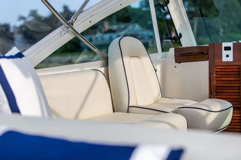 Slide: The Image of 2021 Hunt Yachts Harrier 26 interior with elegant white seating and wooden accents. - 32