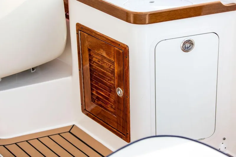 Slide: The Image of 2021 Hunt Yachts Harrier 26 interior with wooden cabinet and sleek design details. - 33