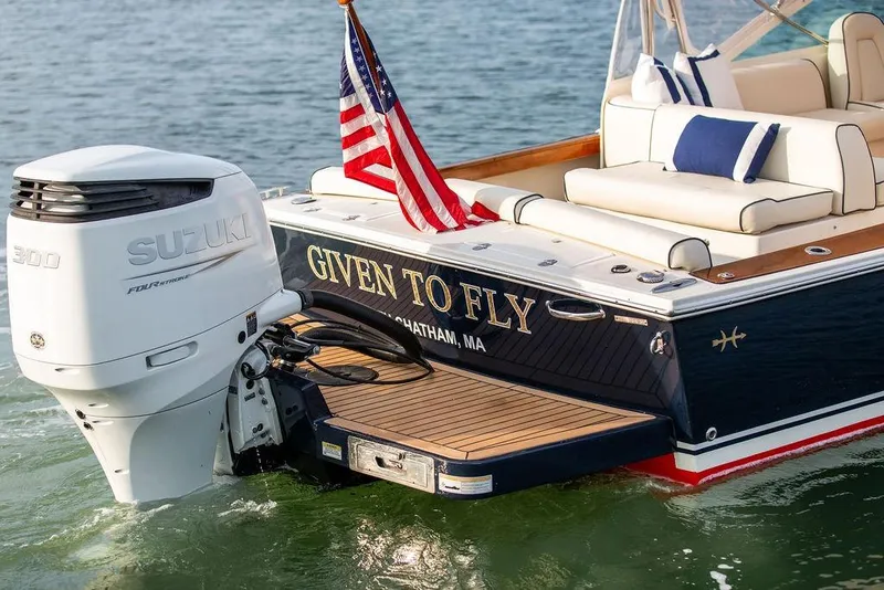 Slide: The Image of 2021 Hunt Yachts Harrier 26 with Suzuki engine, American flag, and luxury seating. - 40