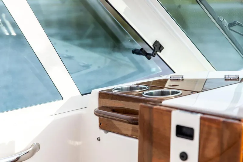 Slide: The Image of 2021 Hunt Yachts Harrier 26 interior detail with wooden accents and cup holders. - 49