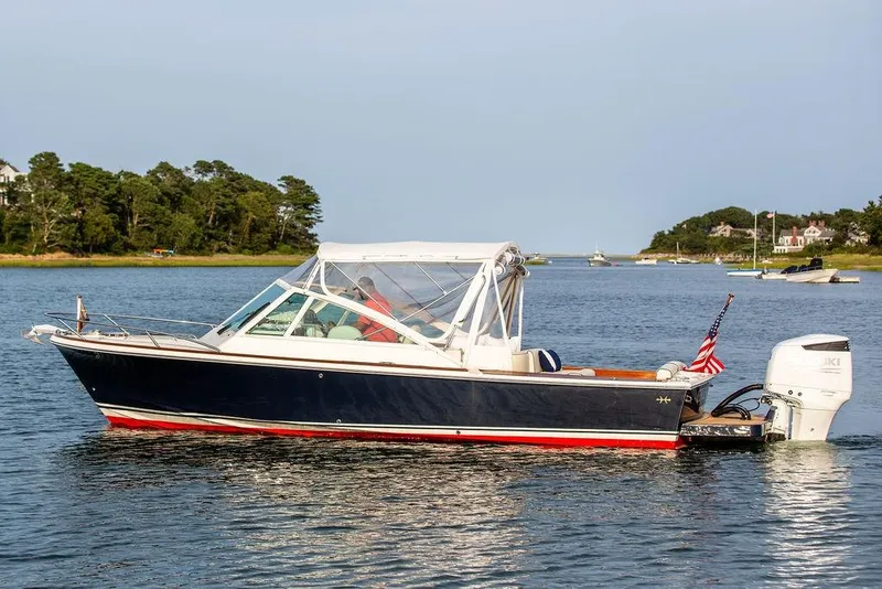 Slide: The Image of 2021 Hunt Yachts Harrier 26 boat on calm water with scenic background. - 55