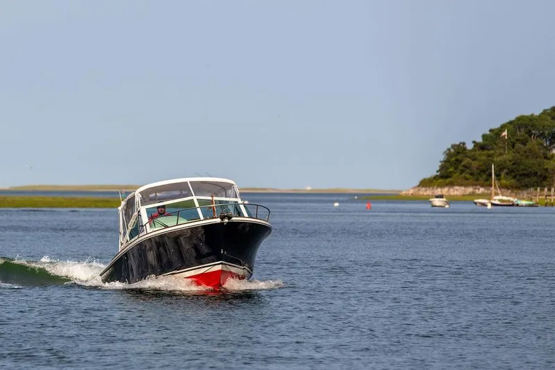 Slide: The Image of 2021 Hunt Yachts Harrier 26 cruising on a serene coastal waterway. - 67