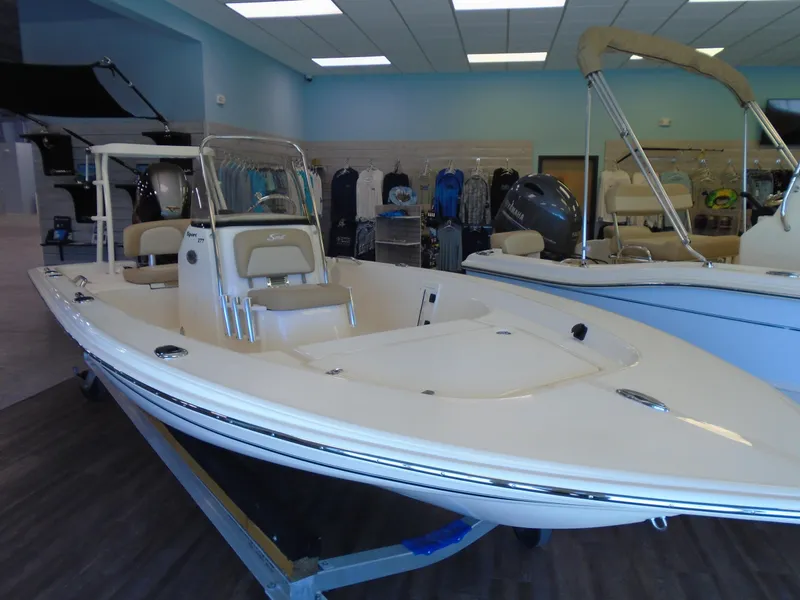 Slide: The Image of 2025 Scout 177 Sport boat displayed in showroom, featuring sleek design and modern amenities. - 1