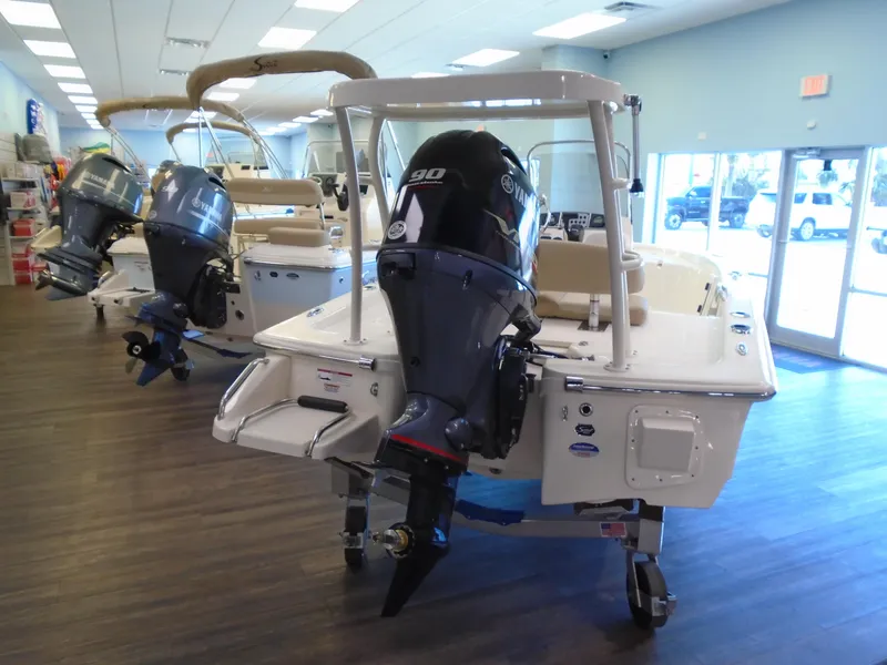 Slide: The Image of 2025 Scout 177 Sport boat with outboard motor displayed in showroom. - 3