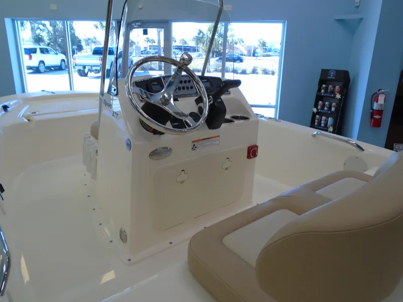Slide: The Image of 2025 Scout 177 Sport boat interior with steering console and seating. - 5